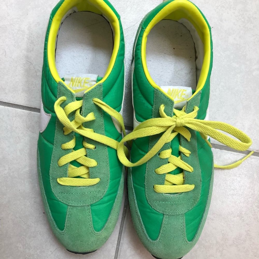 Green and yellow Nike tennis shoes